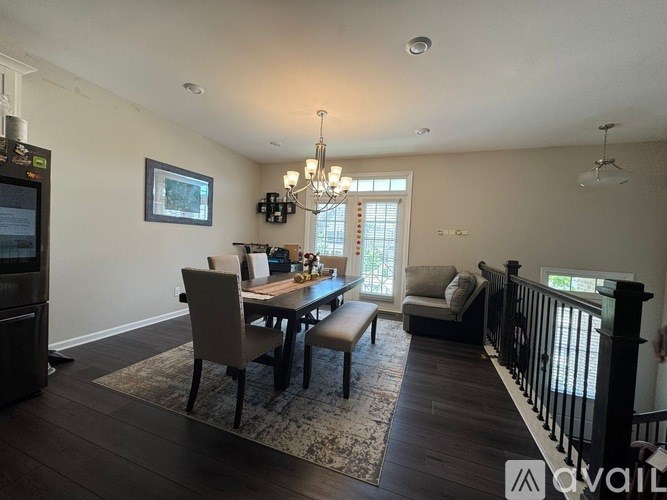 A dining room with a wooden table and chairs.