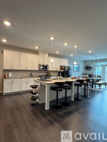 A modern kitchen with a dining area and a large island.