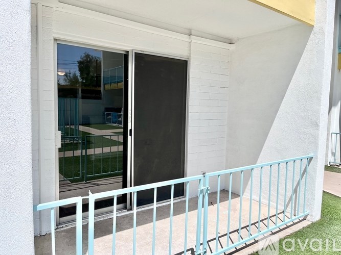 A white house with a black door and a glass window.