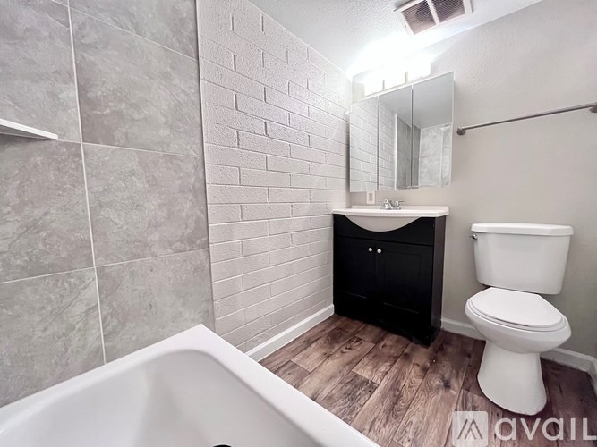 A bathroom with a white toilet and a white sink.