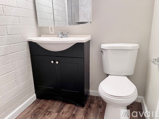 A white toilet sits next to a sink in a bathroom.