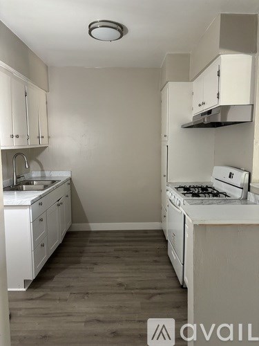 A small kitchen with white appliances and cabinets.