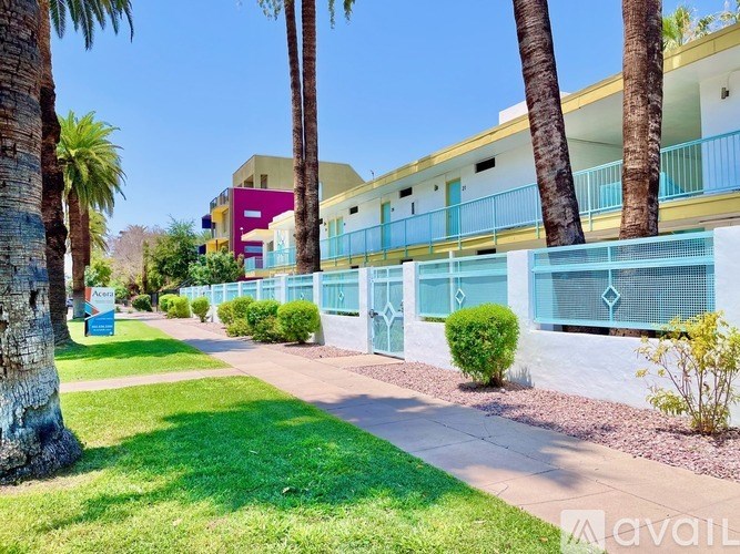 A row of houses with blue railings and white walls.