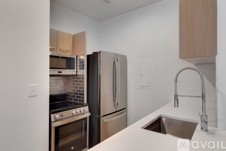 A kitchen with a white countertop and stainless steel appliances.