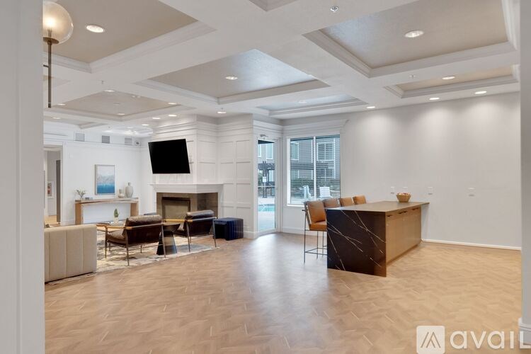 A spacious living room with a fireplace and a television.