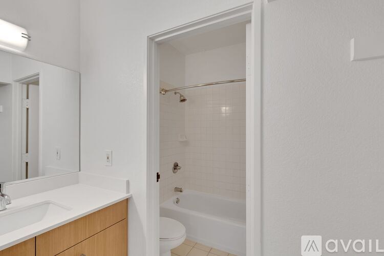 A bathroom with a white sink and a white toilet.