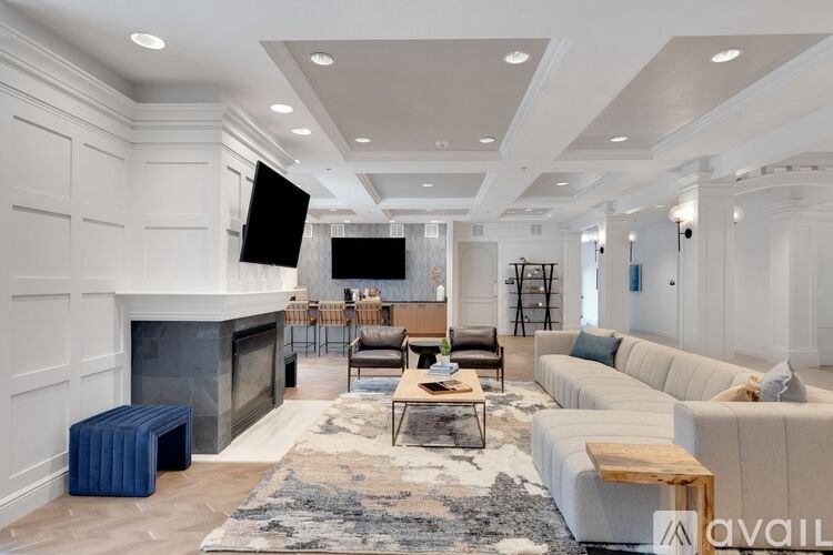 A living room with a fireplace and a television.