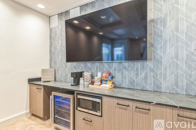 A modern kitchen with wooden cabinets and a large island.