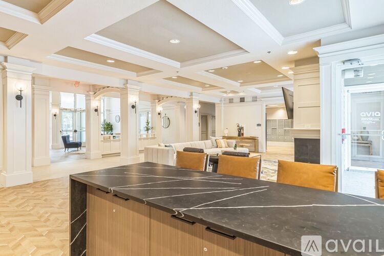 A spacious room with a long table and chairs.