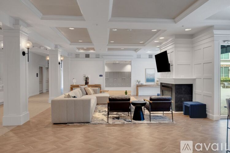 A living room with a fireplace and a television on the wall.