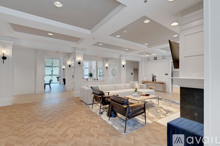 A spacious living room with a fireplace and a large couch.