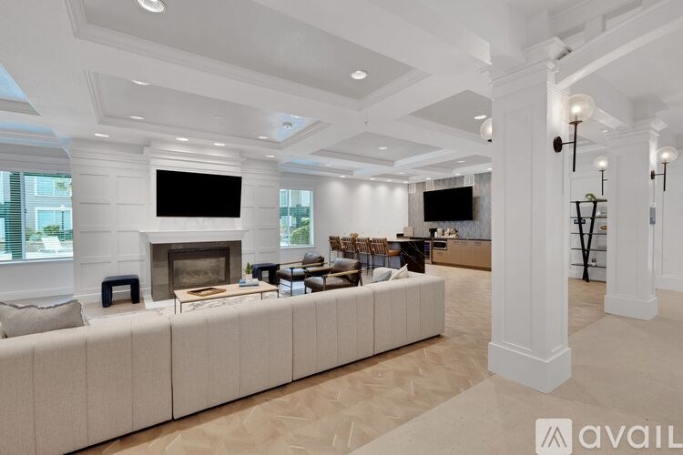 A spacious living room with a fireplace and a large couch.