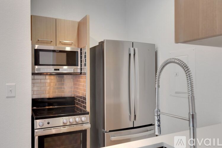 A kitchen with a stove, oven, and refrigerator.