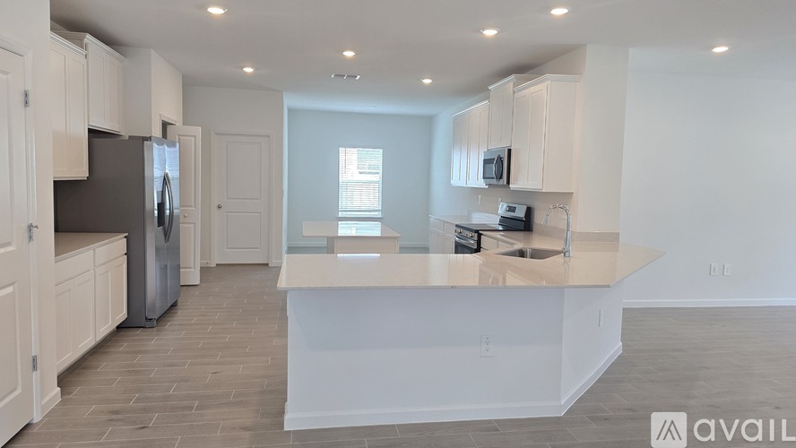 A kitchen with white cabinets and a central island.