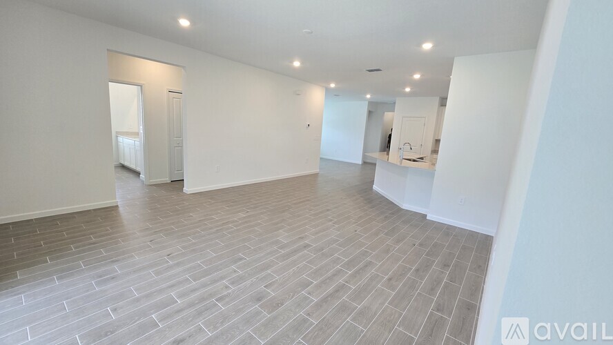 A spacious room with a tiled floor and white walls.