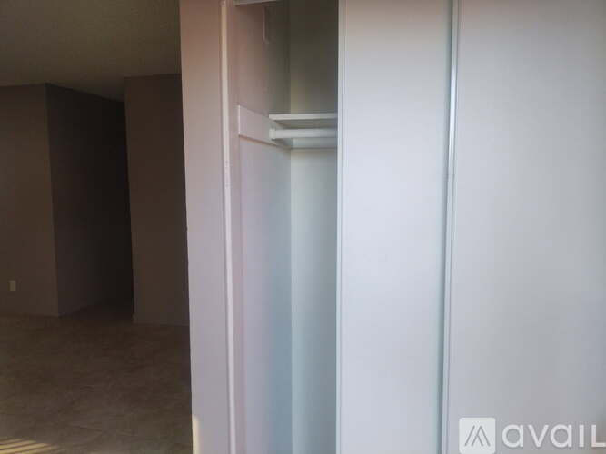 A room with a white door and a brown wall.