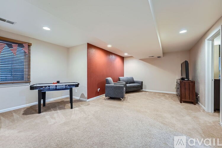 A room with a pool table and a couch.