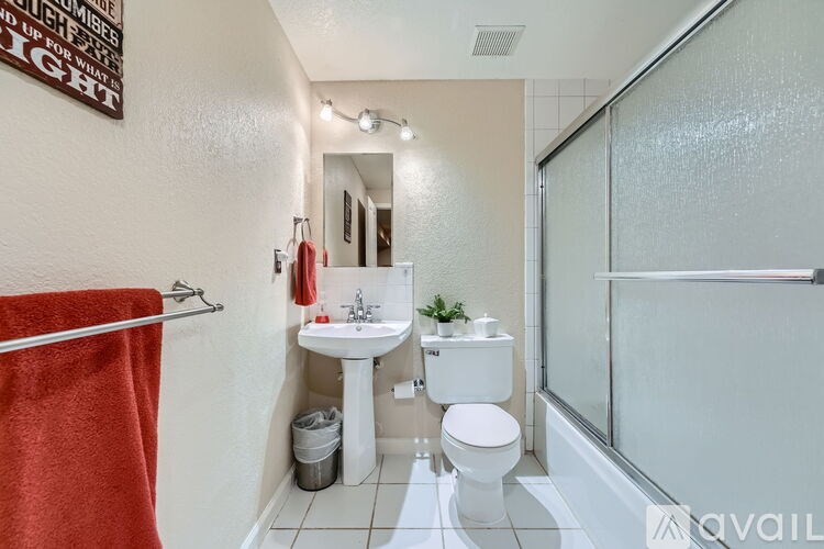 A bathroom with a red towel hanging on a rack.