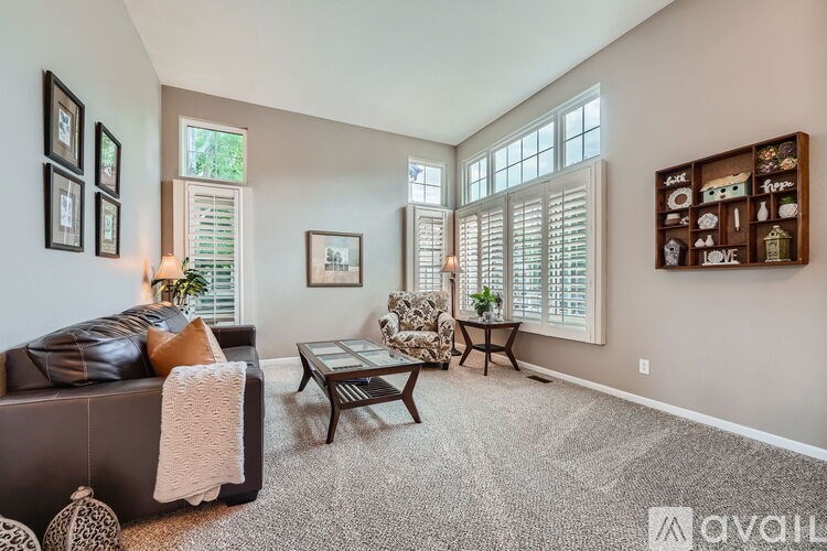 A living room with a couch, chair, and a coffee table.