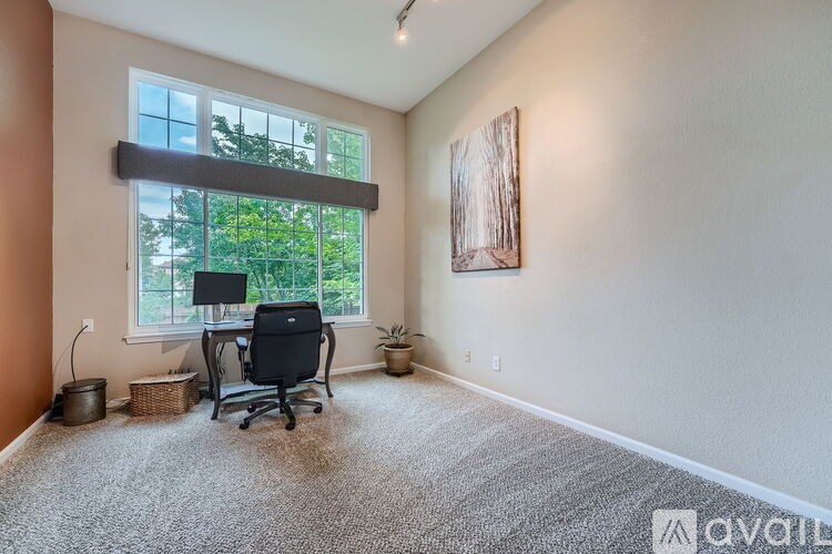 A room with a desk and a window.