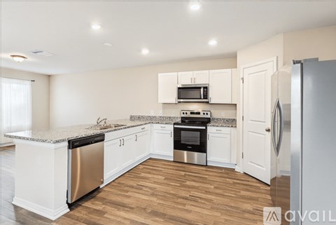 A kitchen with white cabinets and stainless steel appliances.
