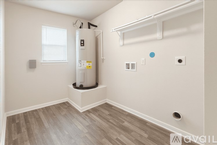 A room with a window, a radiator, and a wall-mounted shelf.