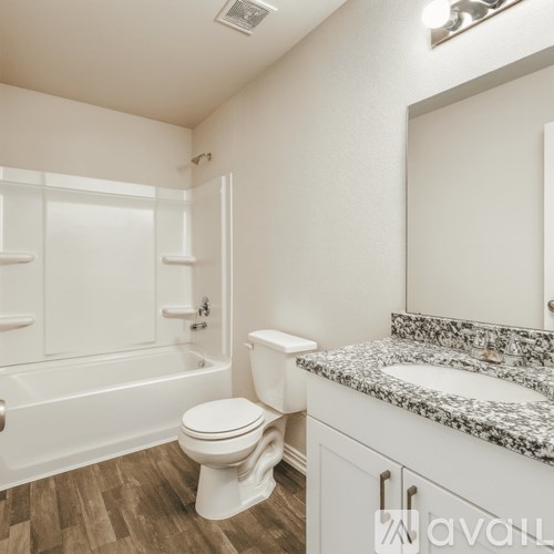 A white toilet sits next to a bathtub in a bathroom.