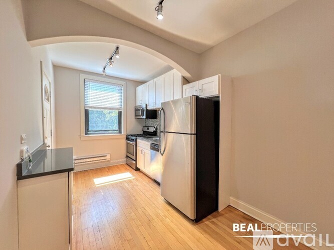 A kitchen with a refrigerator, stove, and oven.