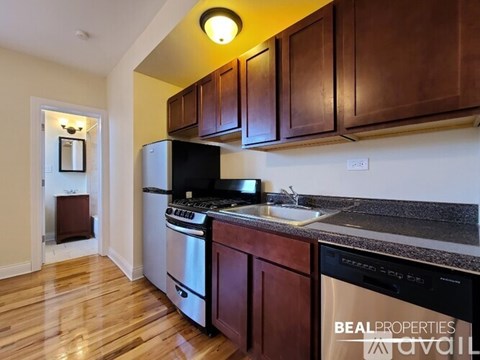 A kitchen with wooden cabinets and stainless steel appliances.
