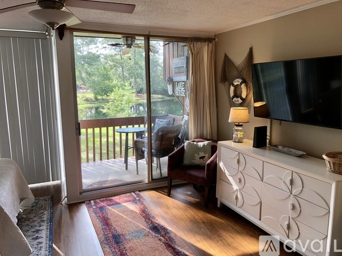 A living room with a sliding glass door leading to a balcony.