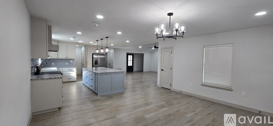 A spacious kitchen with a large island in the middle.