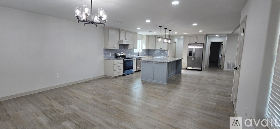 A spacious kitchen with a large island in the middle.