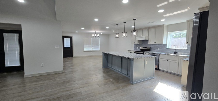 A spacious kitchen with a large island in the middle.