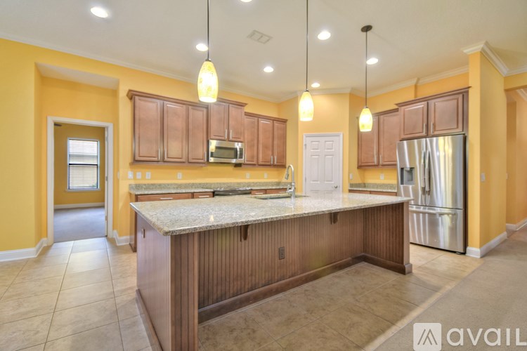 A kitchen with yellow walls and wooden cabinets.