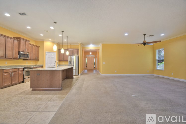 A spacious kitchen with a countertop and a microwave.