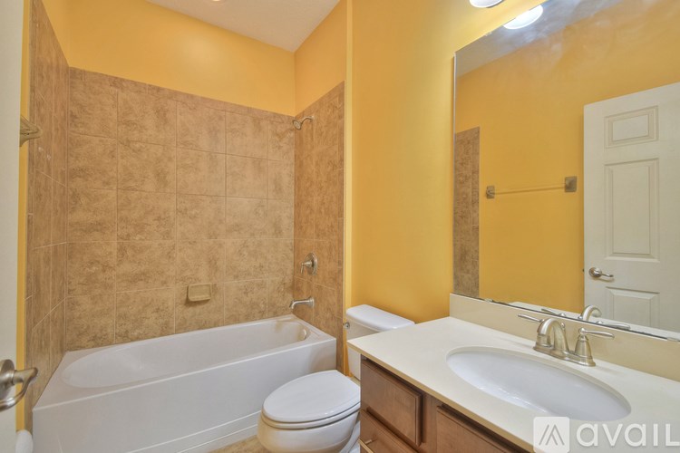 A bathroom with a toilet, sink, and bathtub.