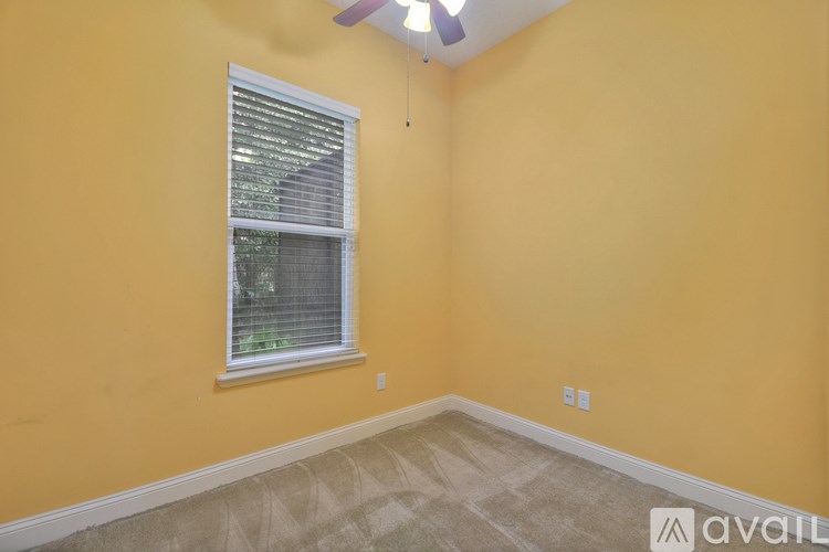 A room with yellow walls and a window with blinds.