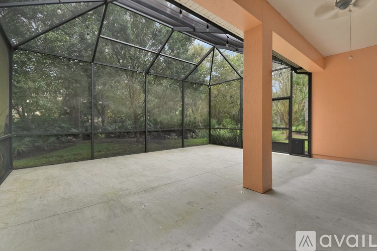 A large, empty room with a glass wall and a concrete floor.