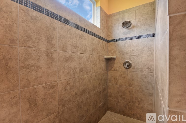 A tiled shower area with a glass door.