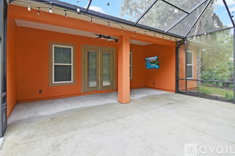 A patio area with orange walls and a glass roof.