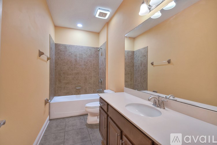 A bathroom with a toilet, sink, and shower.