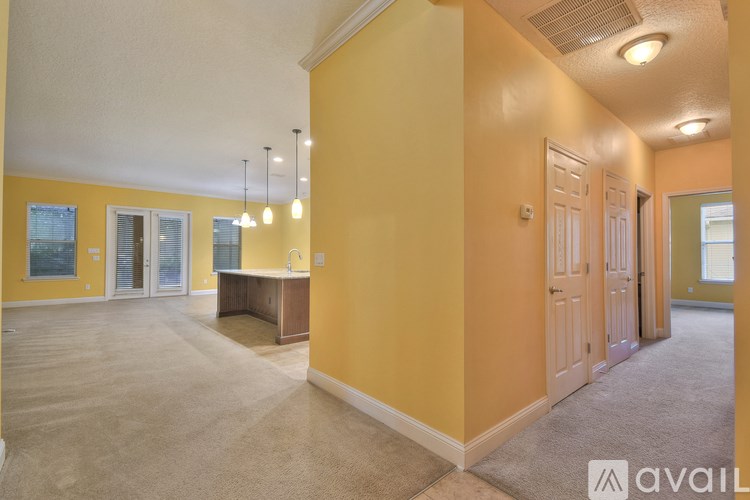 A spacious room with yellow walls and a carpeted floor.
