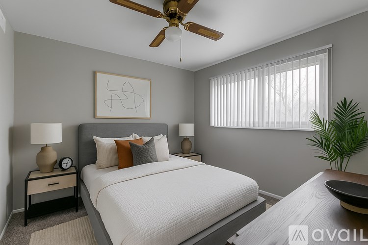 A kitchen with white appliances and wooden floors.