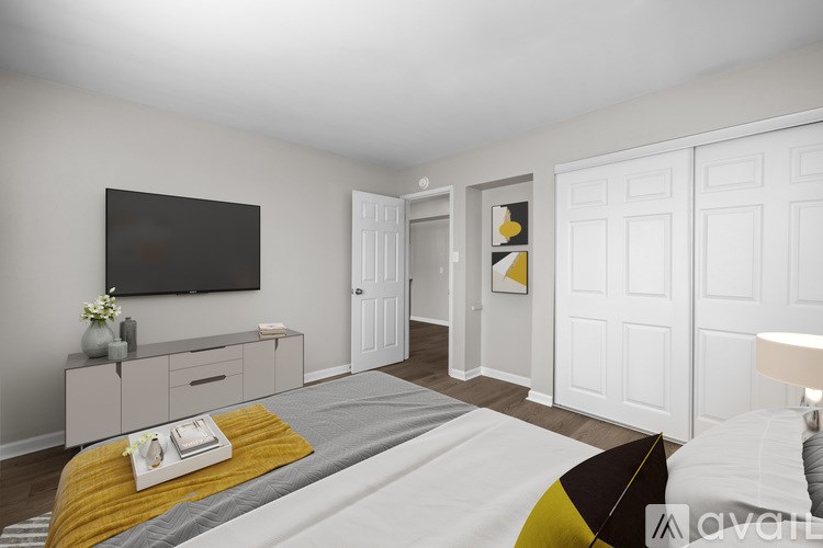 A bedroom with a bed, dresser, and television.