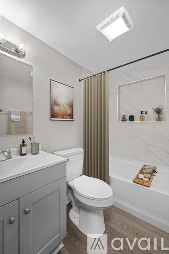 A bathroom with a toilet, sink, and a shower curtain.