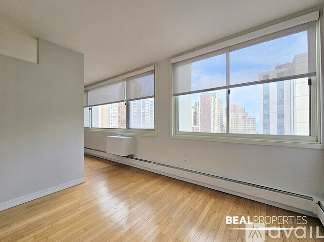 A room with a large window overlooking a cityscape.
