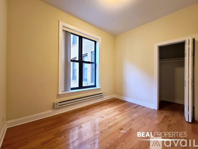 A room with a window and wooden floors is available for rent.