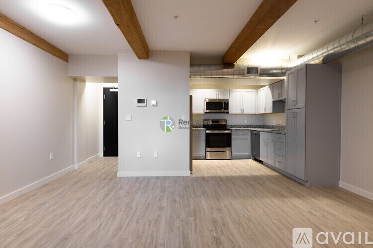 A kitchen area with a white wall and a green arrow pointing to the right.