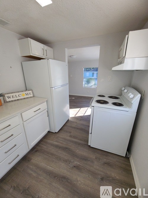 A hallway with a white door and a window.