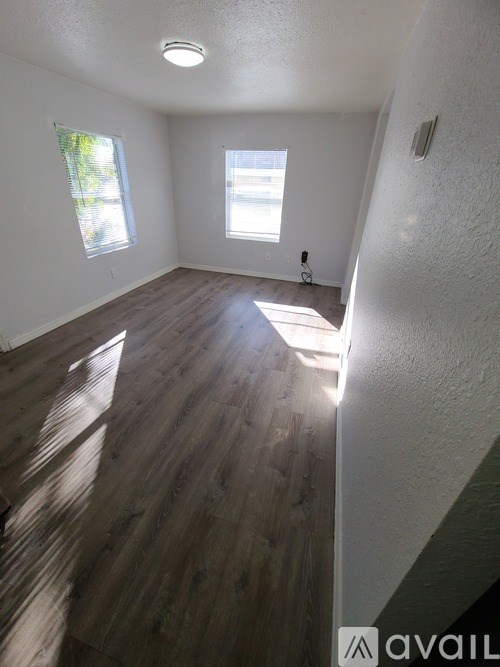 A yellow house with a white door and a white porch.